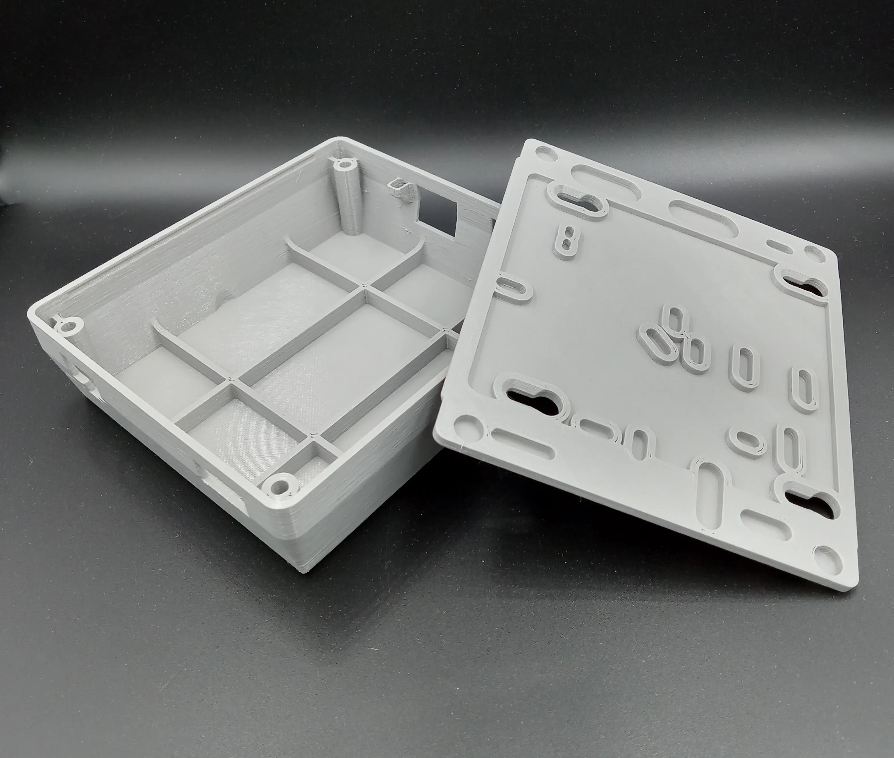 Functional FDM 3D printed electronics enclosure and mounting plate for industrial prototyping in Whitehorse and Calgary.